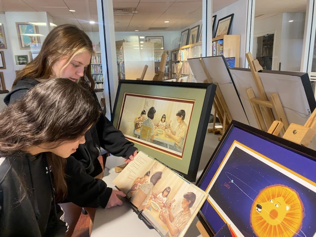 Project FOCUS student Daniela Garcia (first-year) and Elementary Education major Lily Volmer (sophomore) compare an original illustration by Jason Chin to its final version. Chin’s work for Watercress earned the 2022 Caldecott Medal.