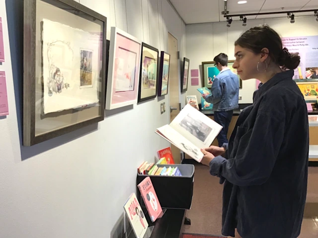 Eva Halvax studies illustrations that Juana Martinez-Neal and Molly Idle say are most representative of their artistic voice. Photo credit: Ileana Roman