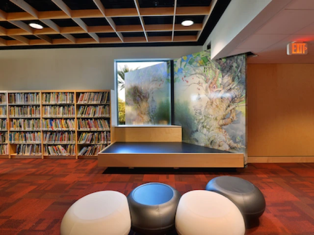 library space with a sitting area and bookcases with books