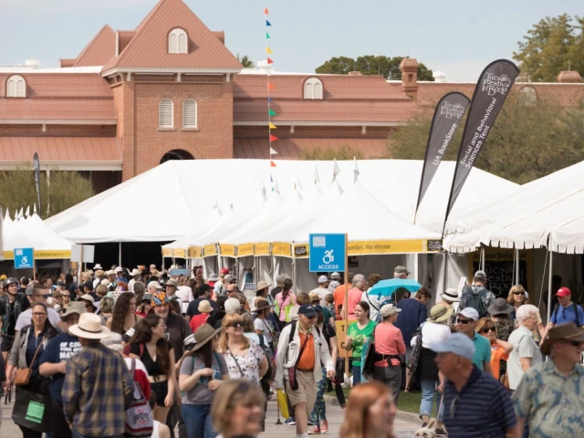 The University of Arizona Old Main on the background with people walking and visiting book exhibits at the 2019 Tucson Festival of Books  