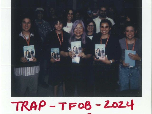 Polaroid of a group holding books and smiling for the camera
