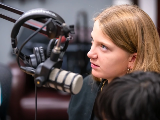 middle schooler speaks into a microphone