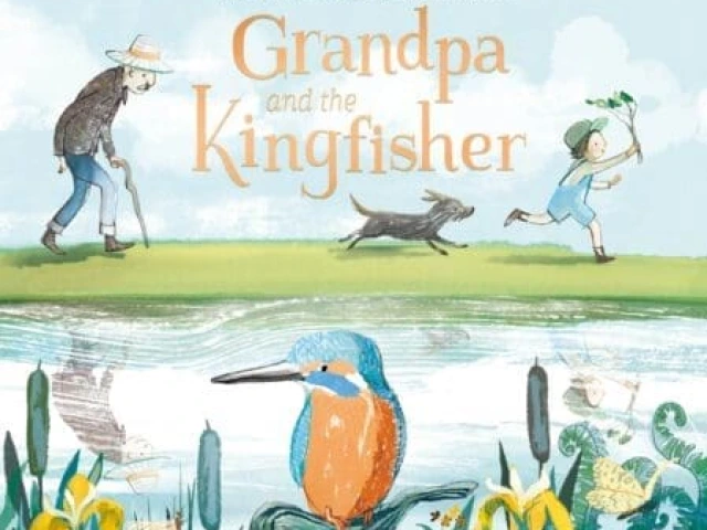 A grandfather walks behind a young boy and dog next to a lake.