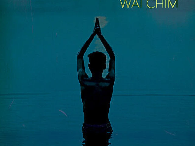 Photo of a boy in the water at night preparing for a swim.