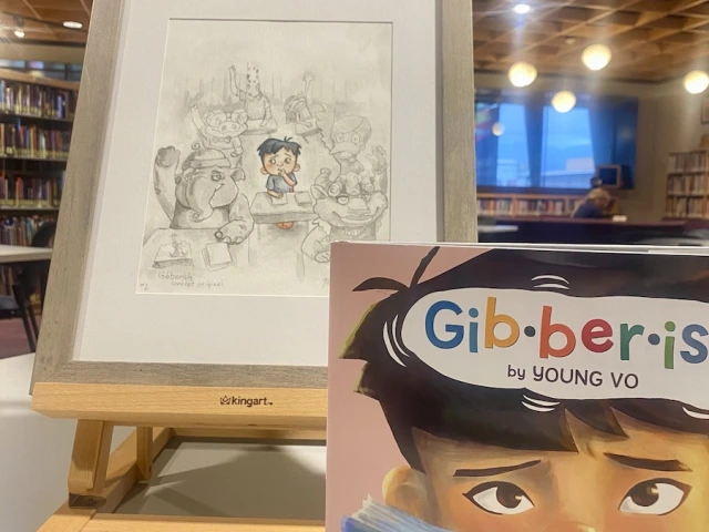 Concept art for Gibberish on a table easel displayed with a final copy of the book