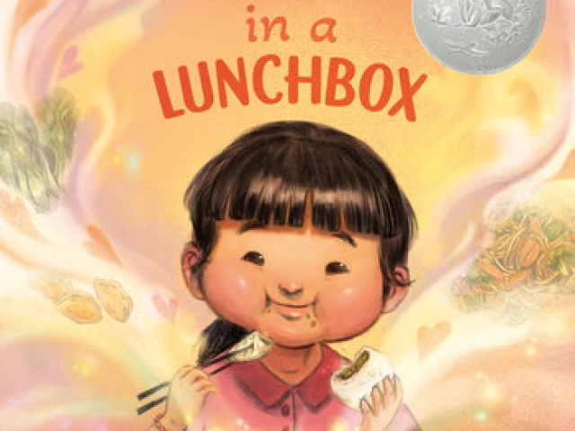 A young girl happily eats from her lunchbox.