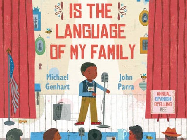 A young Latino stands at a microphone on a stage in front of three judges