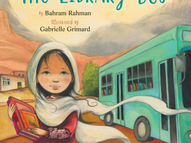 A young girl in a hijab holds b