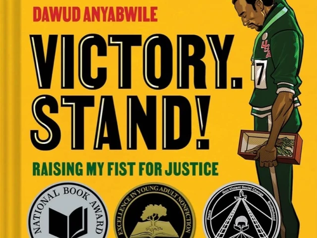 Man standing on the Olympic podium with fist raised