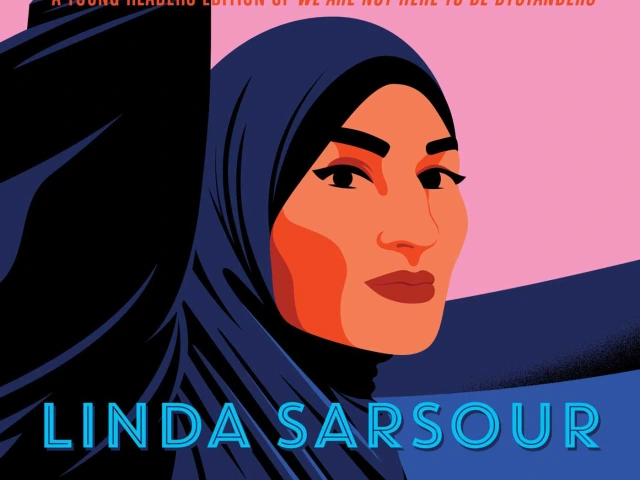 A woman wearing a hijab with her fist in the air.