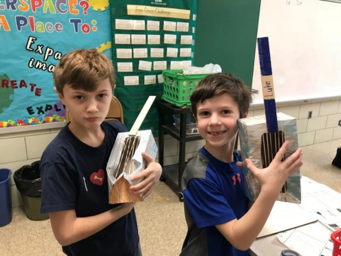 Jacob and Luke chose tissue boxes, paint sticks and rubber bands for their string instrument