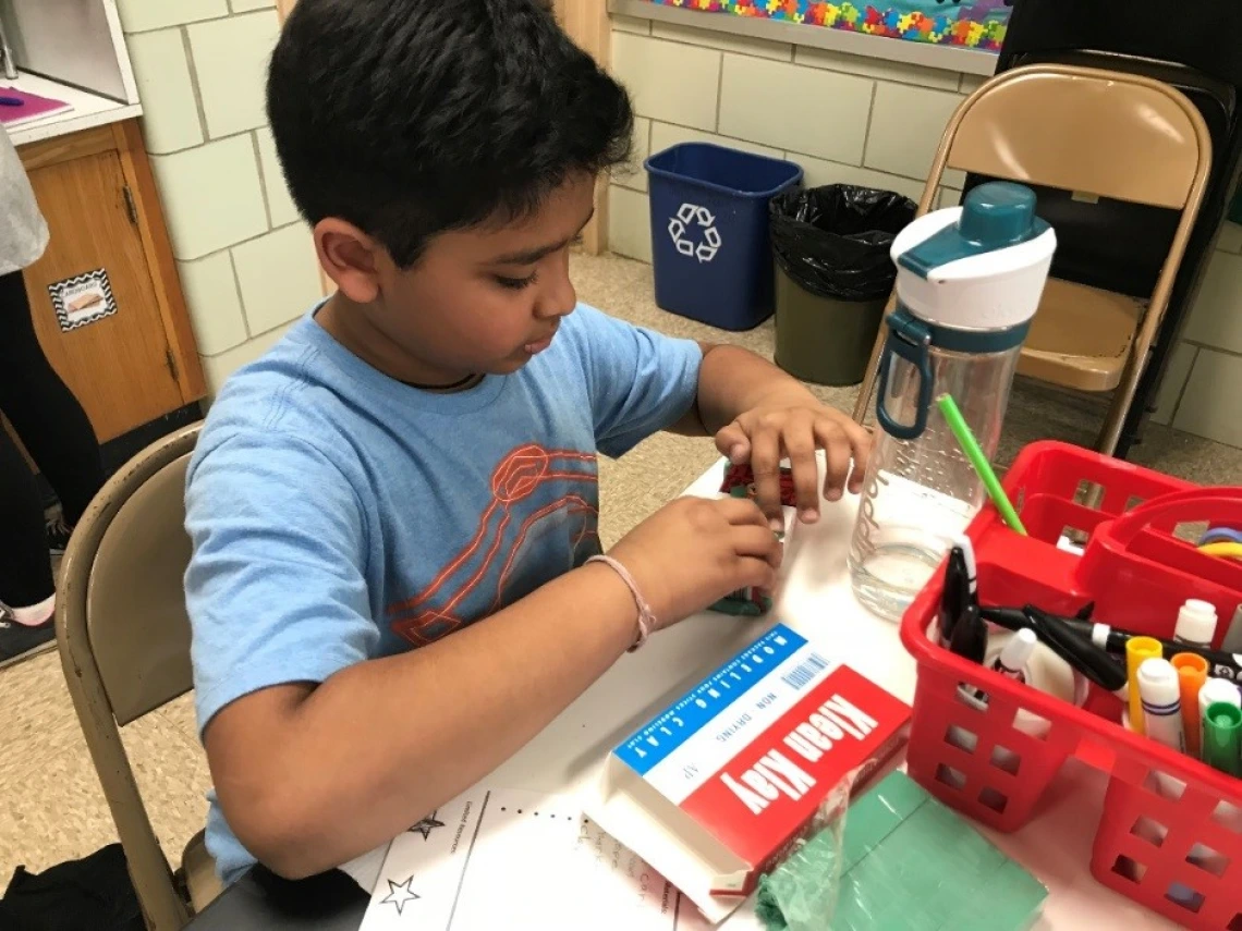 Yug selected clay to add more detail and texture to his instrument