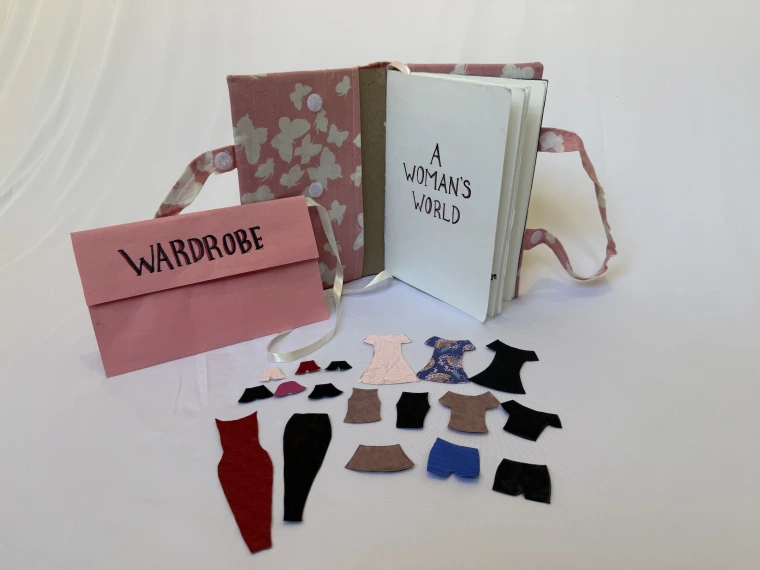 handmade book features paper doll with wardrobe