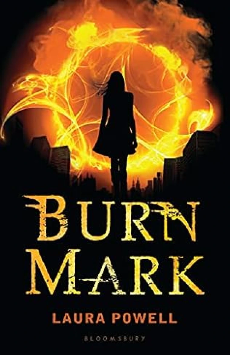 Silhouette of a young woman before a ring of fire.