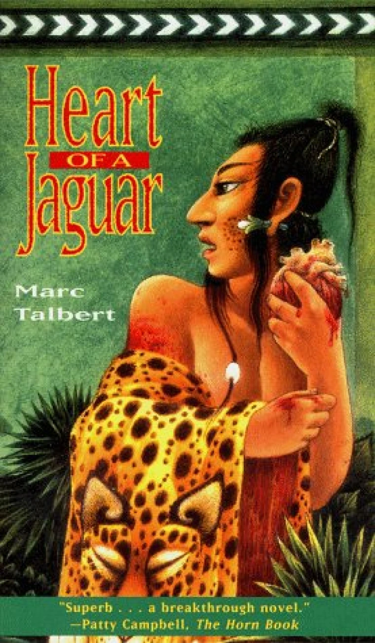 A young Mayan man carries the pelt of a jaguar.