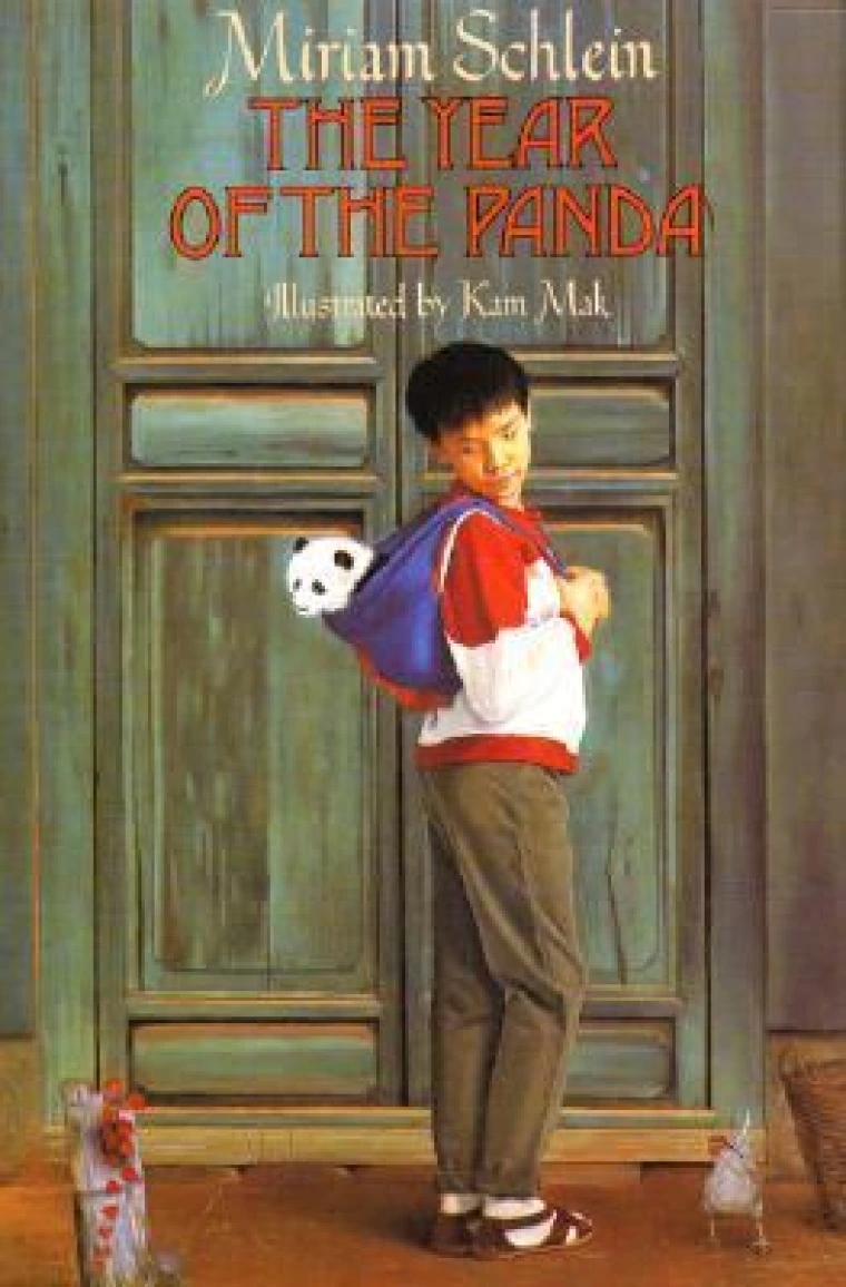A young boy carries a baby panda in a bag.