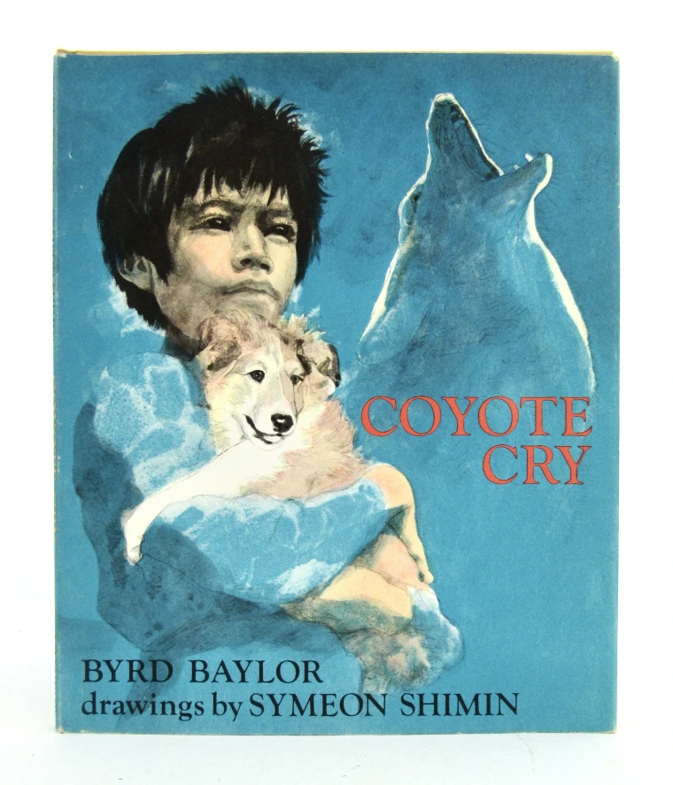A boy hugging a baby coyote