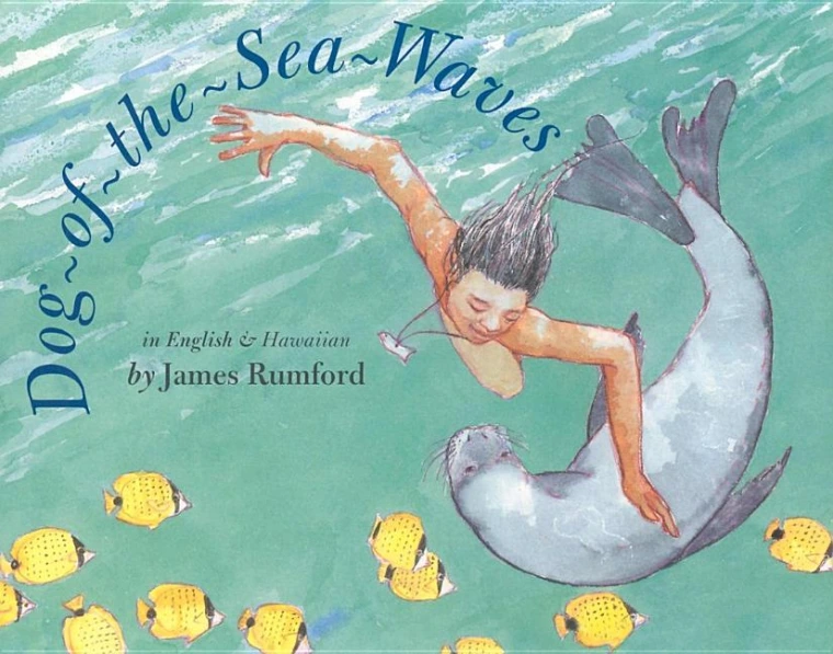 A kid is swimming underwater with a seal