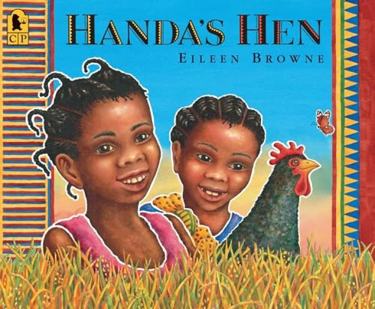 Two African children stand in a field of grass with a hen.