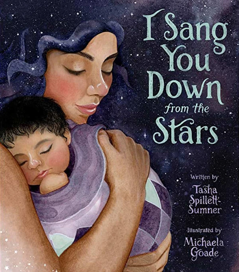 A mother is holding her new born underneath the night sky
