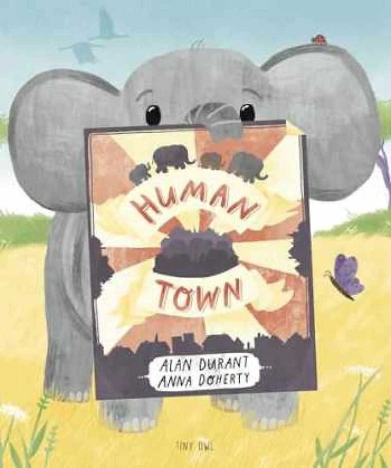 An elephant holds a poster with the title on it.