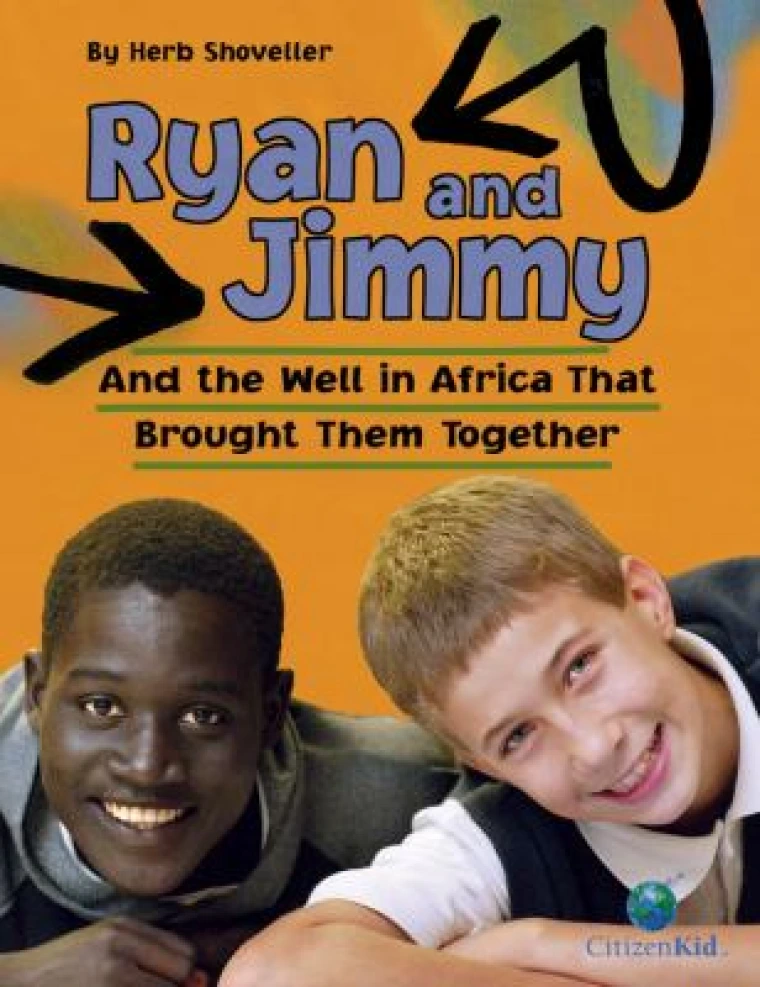 A Black boy and a white boy smile at the camera.