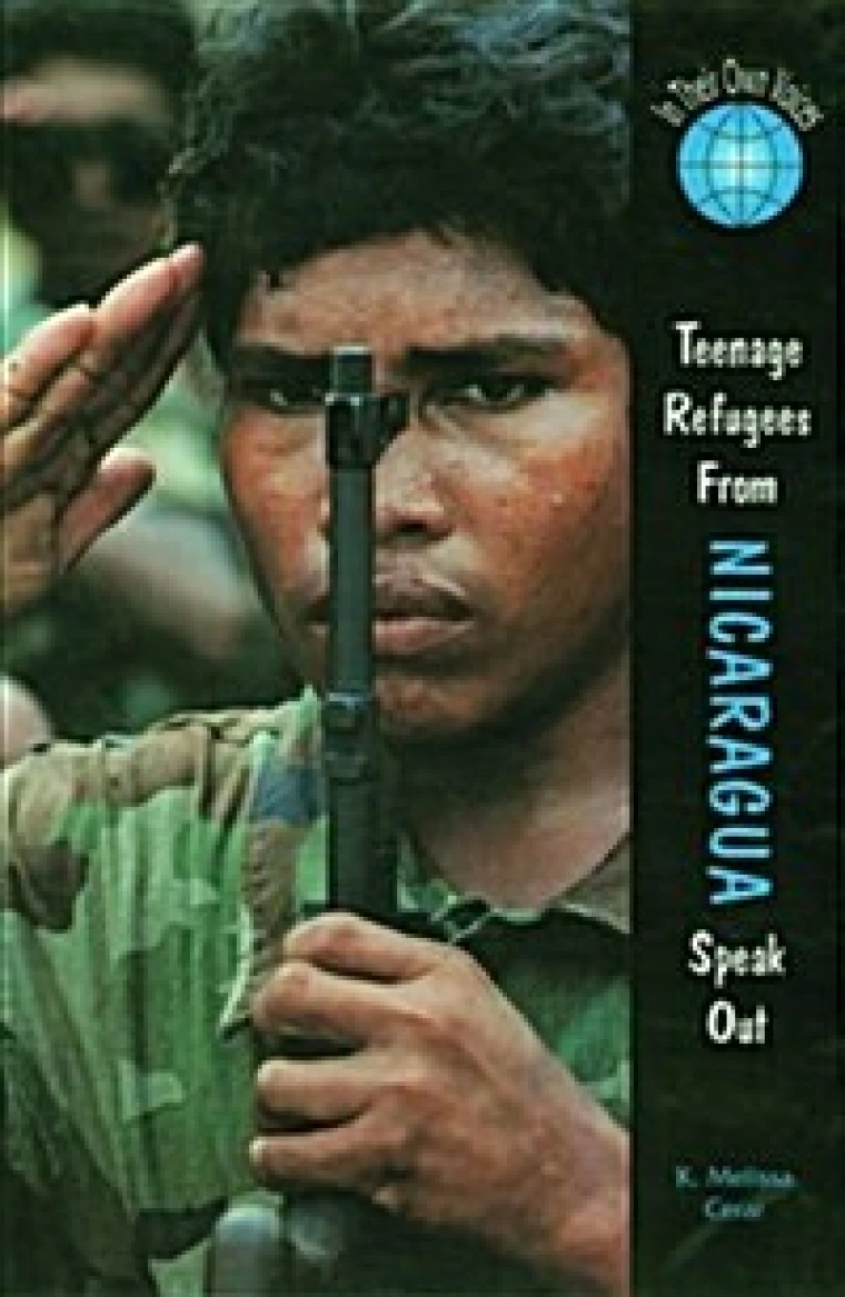 A boy in military garb salutes while holding a gun.
