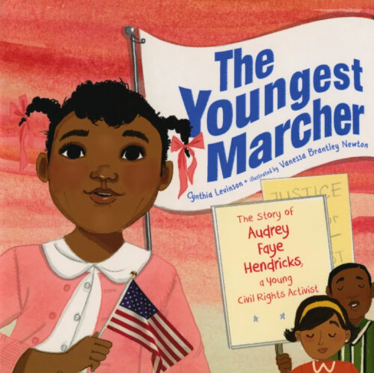 An African American girl holds the American Flag