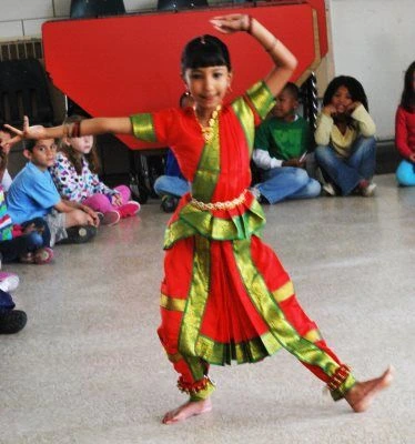 A girl dancing a contemporary Bharatnatyam Indian dance