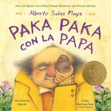 A short balding man with a red nose and cheeks holds a potato  