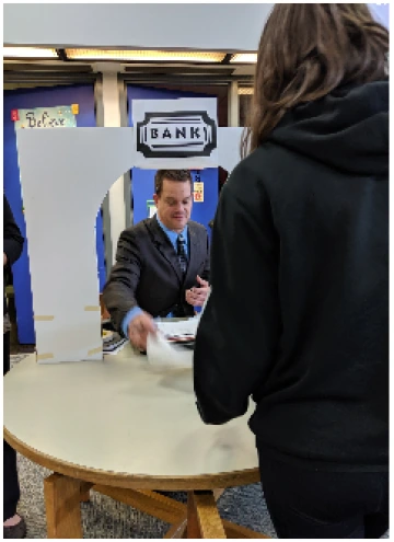 Student Bringing Her Credit Score to the Bank to Get Her APR% from Mr. Walas