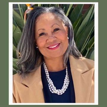 Head shot of Lorri J. Santamaria, a woman with gray hair weraing a blue shirt, tan coat, and pearl necklace. Image taken from her LinkedIn profile.