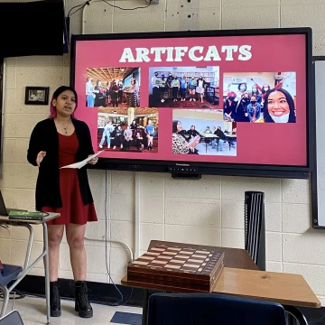 A teen reading ambassador discusses the reading ambassador program as part of a senior capstone presentation.
