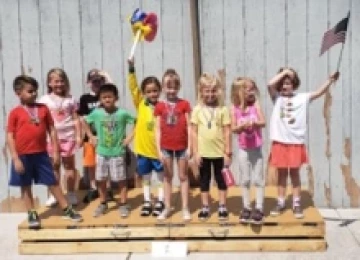 children standing on a platform