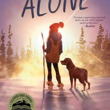 Girl and dog stare into the sunset