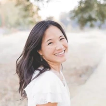 Woman looks over her shoulder smiling