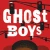 Cover of Ghost Boys depicting the upper half of a black boy's face as he looks up to stop lights that are all red, on a red background.