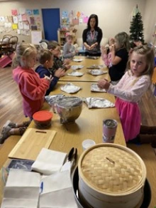 Students making boas with Noel’s mother