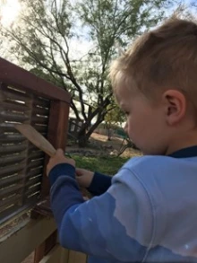 Child playing music at an outdoor music center