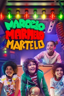 Four smiling children are crouched on a stage.