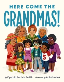 A diverse group of children stand together with their grandmas behind them.