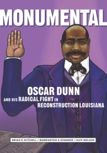 A Black man in a purple suit holds up his right hand.