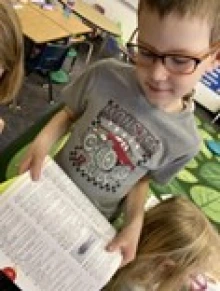 child shows page from a dictionary