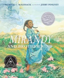 Cover of Mirandy and Brother Wind depicting a young black girl in a blue dress in a field of flowers.