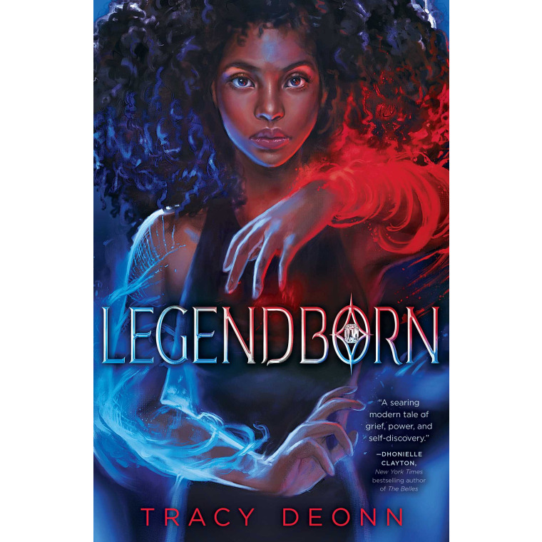 A Black teenage girl’s right arm is covered in red magic and her left arm is covered in blue magic 