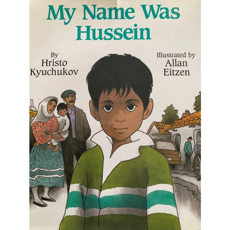 A solemn boy with dark, straight hair looks at the viewer.