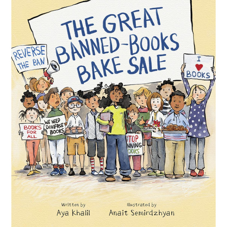 A class of diverse students hold up signs in opposition of banning books.