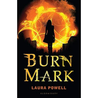Silhouette of a young woman before a ring of fire.