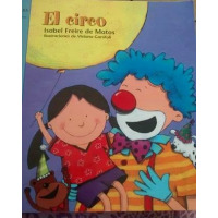 A smiling clown holds a young girl who has a yellow balloon.