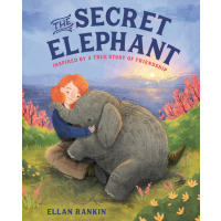 A young girl with red hair hugs a baby elephant.